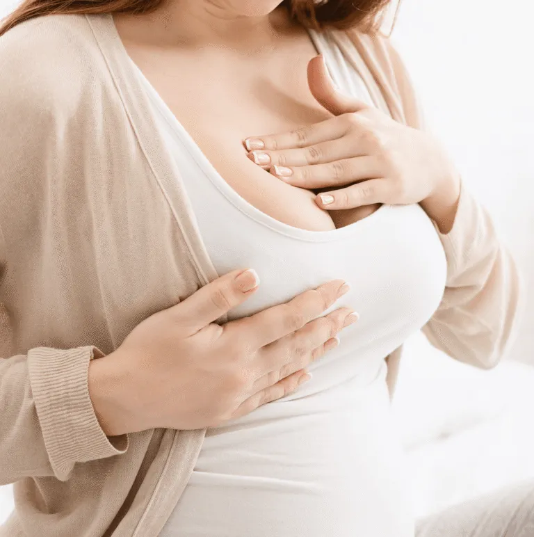 Pregnant woman holding her hands to her chest